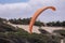 A man flying a paraglider over sand dune of Cape Kiwanda