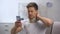 Man in foam cervical collar reading message on cellphone, feeling pain in neck