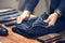 Man folding jeans on wooden table