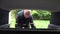 Man folds a cardboard box in the trunk of a car