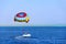 Man is fond of parasailing over Red Sea. People rest on Egyptian resort