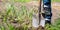 Man foot digs soil with shovel on vegetable garden closeup