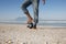 Man With Foot On Soccer Ball At Beach