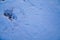 Man footprints left on snow surface close-up