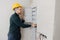 Man foreman builder check checking electrical panel and work of electrician in apartment