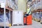 Man on forklift loading boxes at warehouse