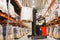 Man on forklift loading cargo at warehouse