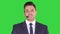 Man in formal clother with a headset presenting something on a Green Screen, Chroma Key.