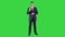 Man in formal clother with a headset presenting something on a Green Screen, Chroma Key.