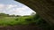 Man framed underneath an arch walking away