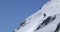 Man freeride skiing down snowy mount ridge in sunny day. Mountaineering ski activity. Skier people winter snow sport in