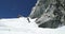 Man freeride skiing down snowy mount ridge in sunny day. Mountaineering ski activity. Skier people winter snow sport in