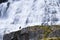 Man in front of an immense waterfall