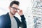 Man in front of shelf with glasses in optician shop