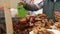 Man frying greasy meat on grill at street festival, harmful unhealthy junk food