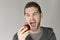 Man with funny face looking at an apple