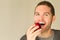 Man with funny face looking at an apple