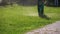 Man Gardener Mows the Grass on the Lawn using a Gasoline Mower in the Park. Slow Motion