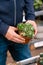 Man gardener shopping in garden center, buying cactus houseplant