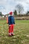 Man gardener wearing protective clothing and full face respirator mask with dust filters and backpack, knapsack, shoulder-mounted