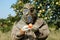 Man in gas mask holding apple