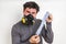 Man with gas mask is holding stinky sock