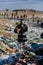 Man with gas mask and plant on landfill standing on landfill, large pile of waste, environmental concept and eco