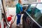 Man at gas station filling up the car with petrol in Bucharest, Romania, 2020