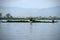 Man gathering algae on boat on Inle lake in Burma