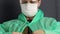 A man with a gauze protective mask and glasses on his face. He wears a protective coat and fastens with buttons. Virus protection