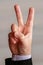Man gesture shows victory sign. Two fingers raised up_