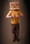 man gesturing with a cardboard box on his head with evil f