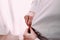 Man gets ready for work by buttoning up his business shirt. Groom`s morning preparation before wedding