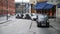 A man gets into a waiting black London taxi cab outside King`s Cross St. Pancras Railway Station and the taxi driver waves to