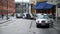 A man gets into a waiting silver London taxi cab outside King`s Cross St. Pancras Railway Station. The taxi then drives away