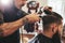 Man getting trendy haircut in barber shop