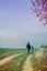 Man and girl child walking together in autumnal colorful nature in rural path in sunny day with happy tranquil atmosphere