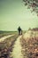 Man and girl child walking together in autumnal colorful nature in rural path in sunny day with happy tranquil atmosphere