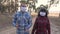 Man and girl couple walk in the forest park in medical masks teamwork happy family. Concept pandemic virus epidemic