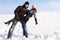 Man and girl dance on snowy area and smiling