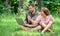 Man and girl looking at laptop screen. Couple youth spend leisure outdoors with laptop. Modern technologies give