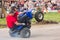 Man with girl rides on the rear wheels on a quad bike