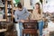 Man with girlfriend admiring vintage wooden bureau