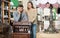 Man with girlfriend admiring vintage wooden bureau