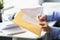 Man give yellow envelope to courier for further delivery to personal address