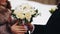 A man gives his girlfriend a beautiful bouquet of flowers. Close up. Nice shot. Love and family.