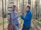 Man gives to the woman a bouquet of snowdrops in a birchwood in the spring, toning