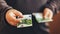 Man giving money cash. Male hands holding hundred euro banknote bill. Credit