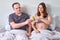 Man giving money in euros in bed to pregnant womanÐ± concept