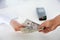 Man giving money to teller at cash department window,